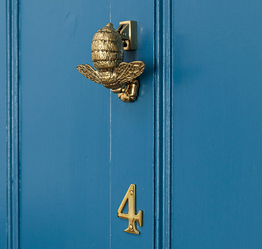 bright blue front door with polished aged brass fittings