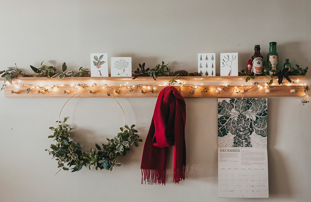 peg rail with Chrsitmas foliage, scarf and wreath