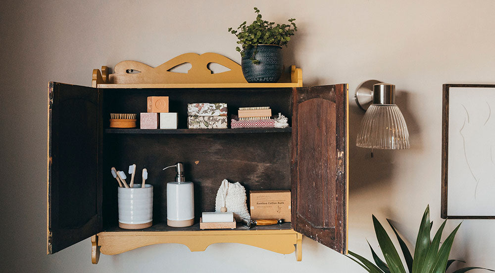 yellow wall mounted cupboard with eco toiletry's inside