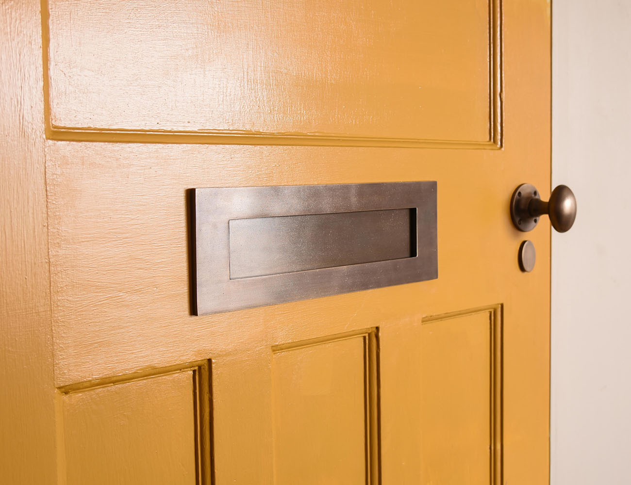 Distressed Antique Brass fittings on a Mustard yellow front door