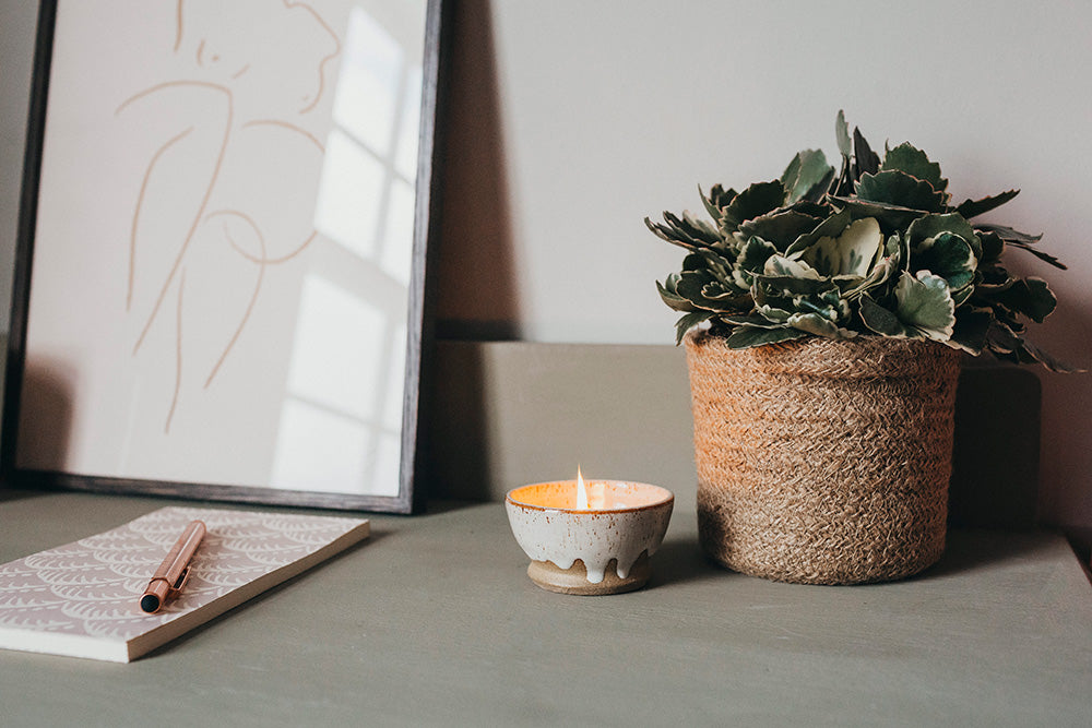 candle in bowl on bedside table