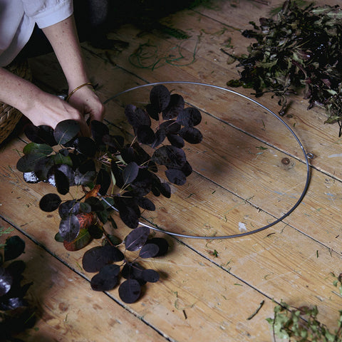 Attaching foliage to a wire wreath hoop