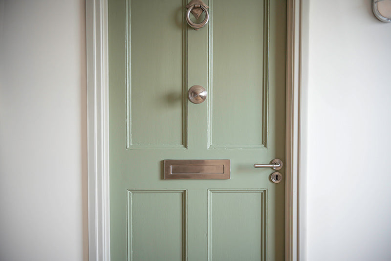 marine grade stainless steel door furniture on pale green door