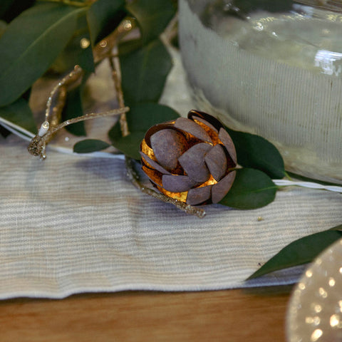 Pinecone fairy light garland on festive table