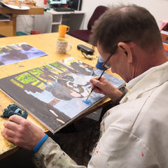 Disabled artist, clive mealin  hard at work in the studio