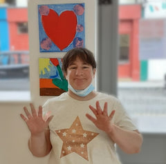 Disabled artist, Debbie with her art in gallery