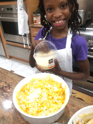 Little girl making mac and cheese
