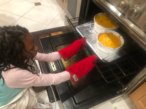 Little Girl Putting Mac and Cheese in over for Mac and Cheese recipe