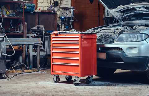 car at the garage with big red toolbox