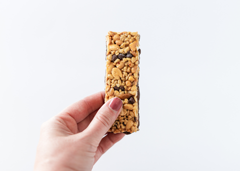 woman holding granola bar