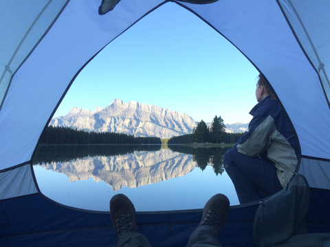 woman looking at view outside tent