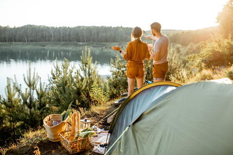 man and woman standing outside tent