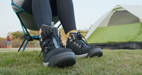 person with hiking shoes sitting on chair