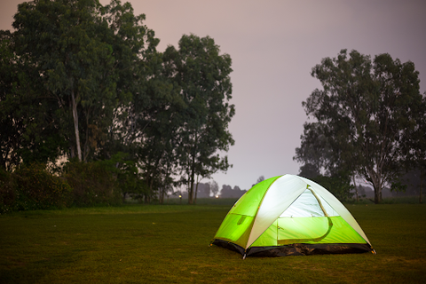 tent lit up in night campsite