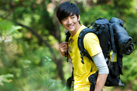 man in yellow hiking shirt and backpack