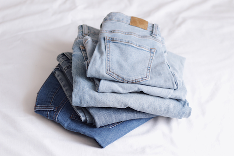 stacking different colored folded jeans