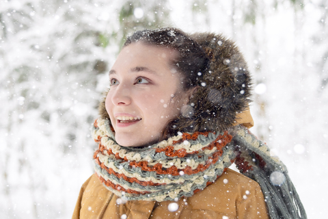 happy woman in winter gear enjoying the snow