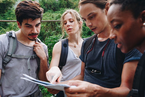 group of campers looking at map and figuring out directions