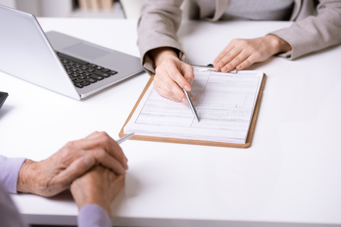 hands resting on table looking over at documents