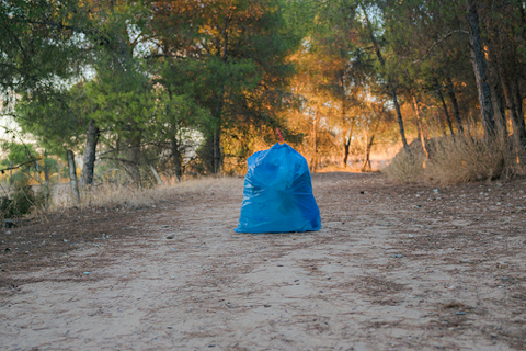 full garbage bag on camp site