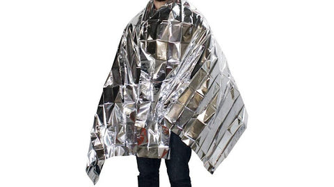 A silver emergency blanket wrapped around a persons shoulders