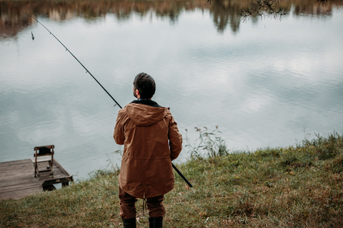 A man at the lake fishing