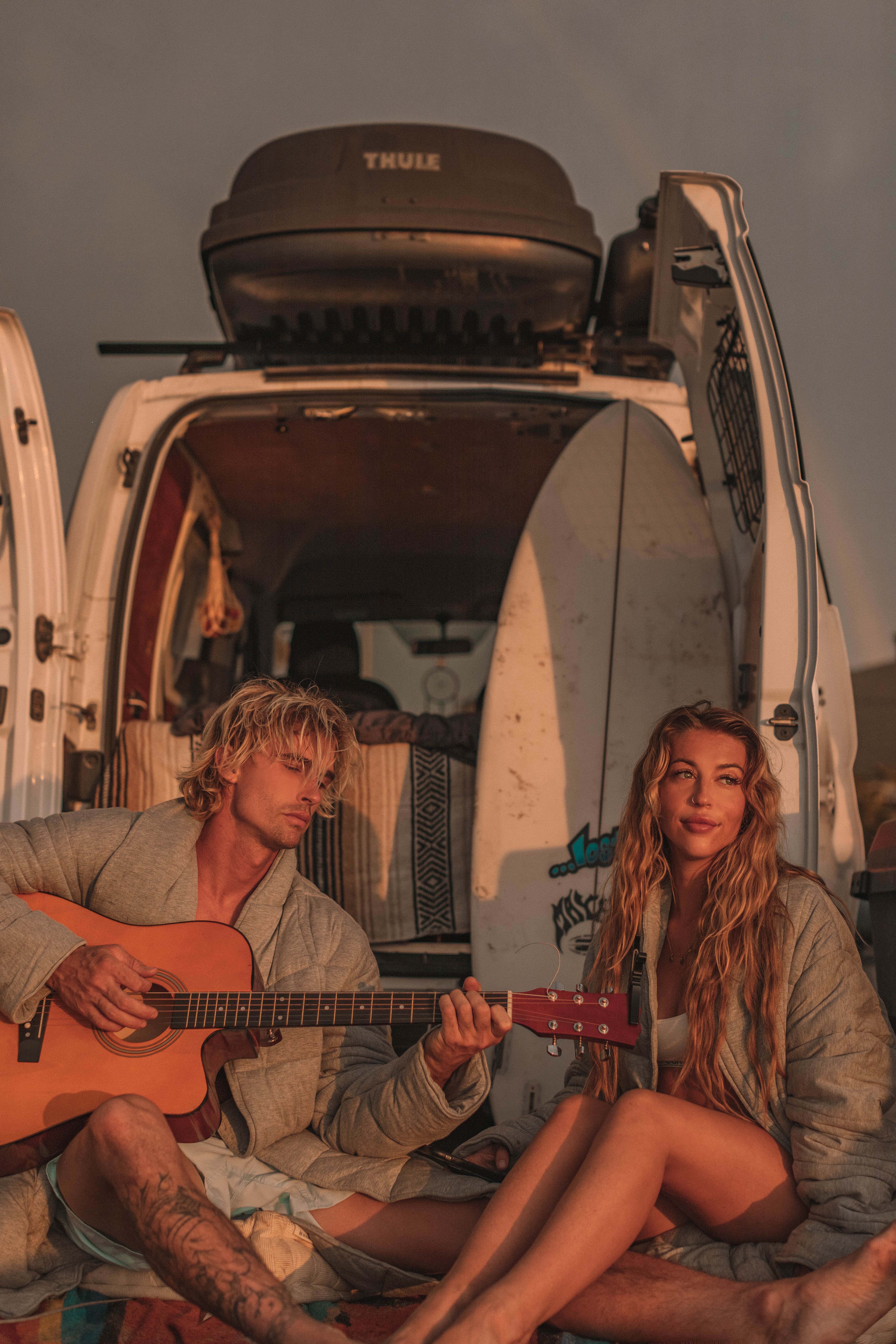 West Coast Road Trip, Couple in front of the van playing guitar