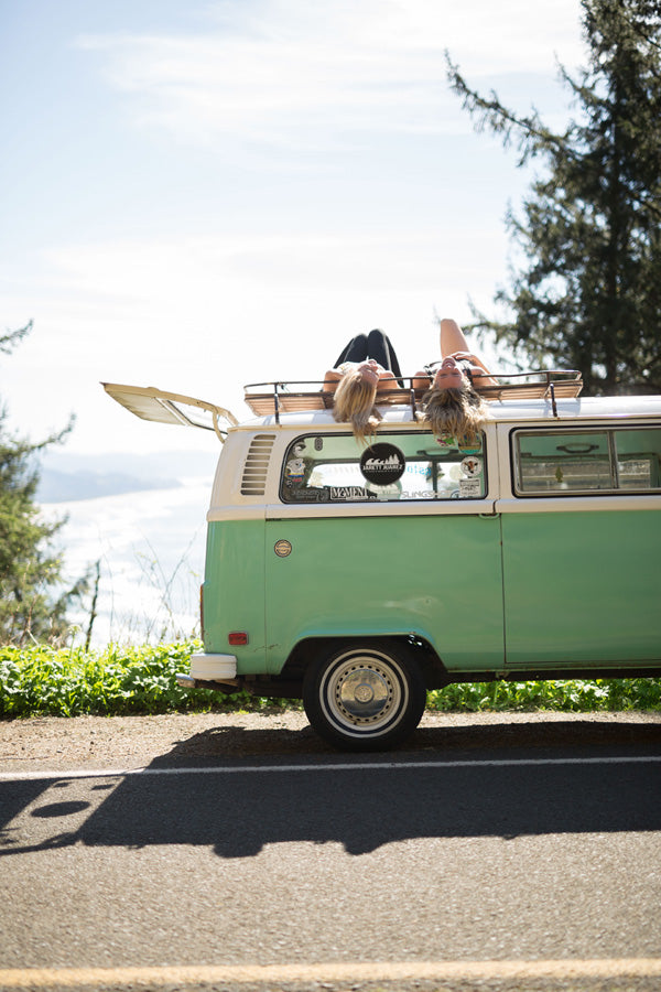 Relaxing on the roof of a VW Bus by the sea!