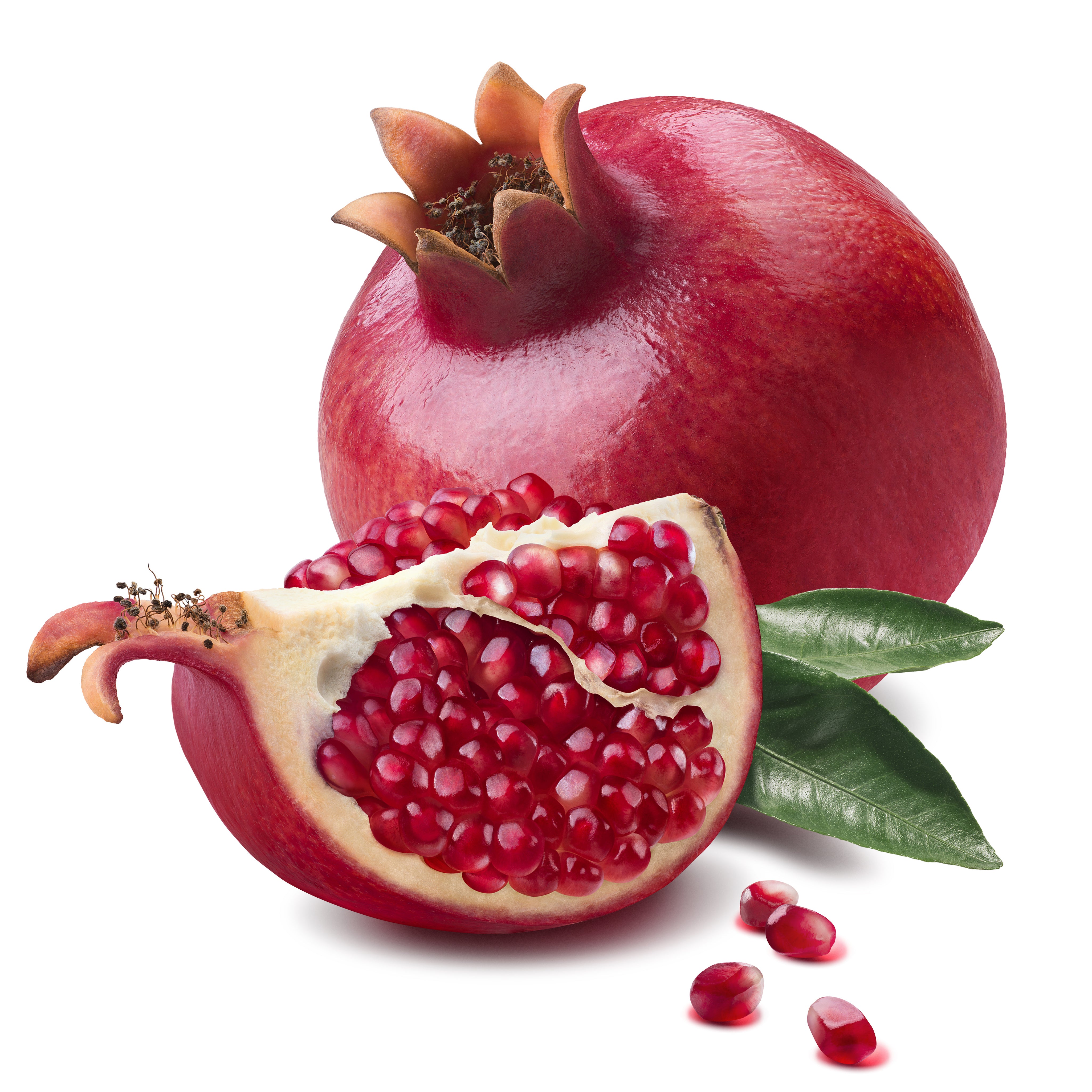 Pomegranate cut and whole on white background