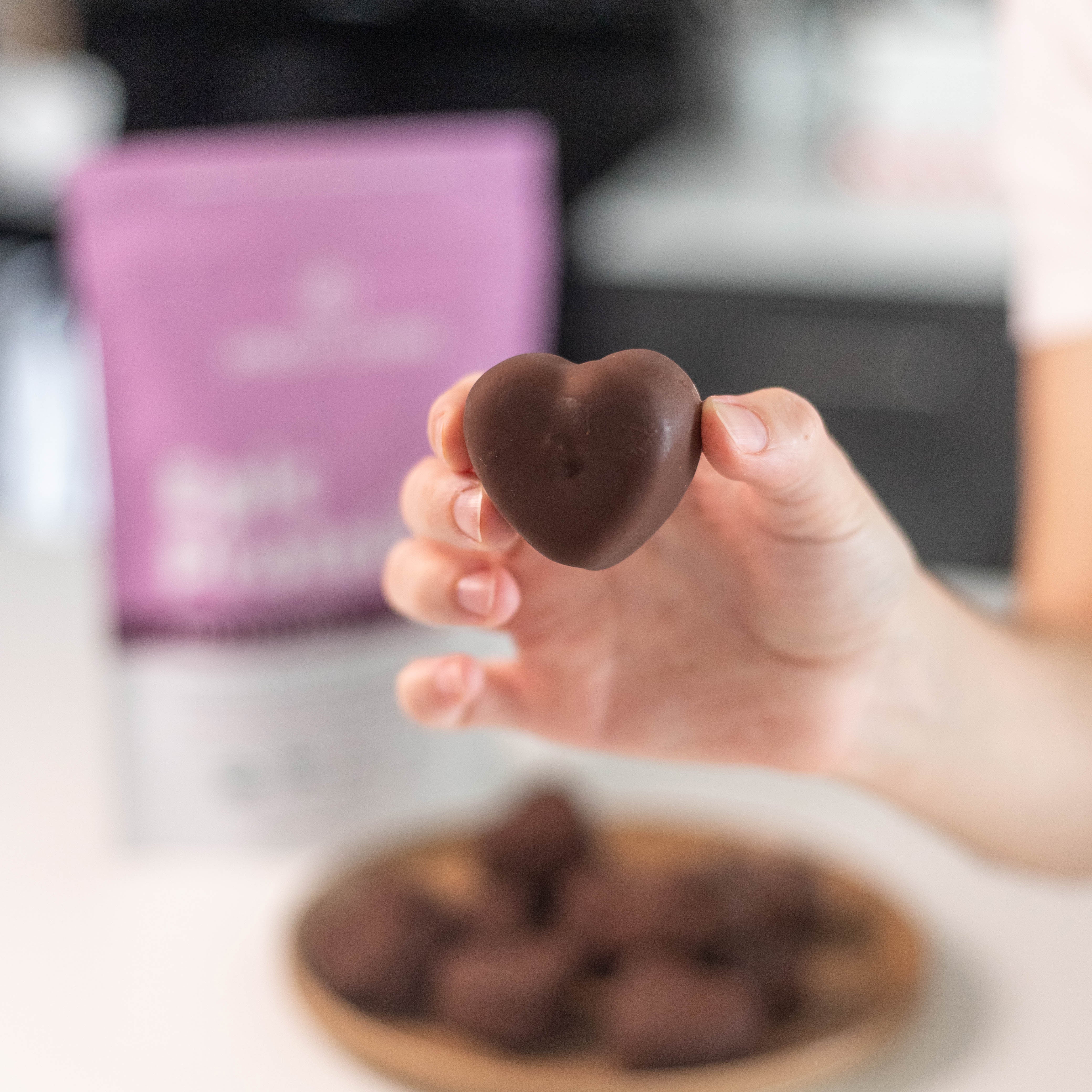 Hand Holding Strawberry Heart Yogurt Bite