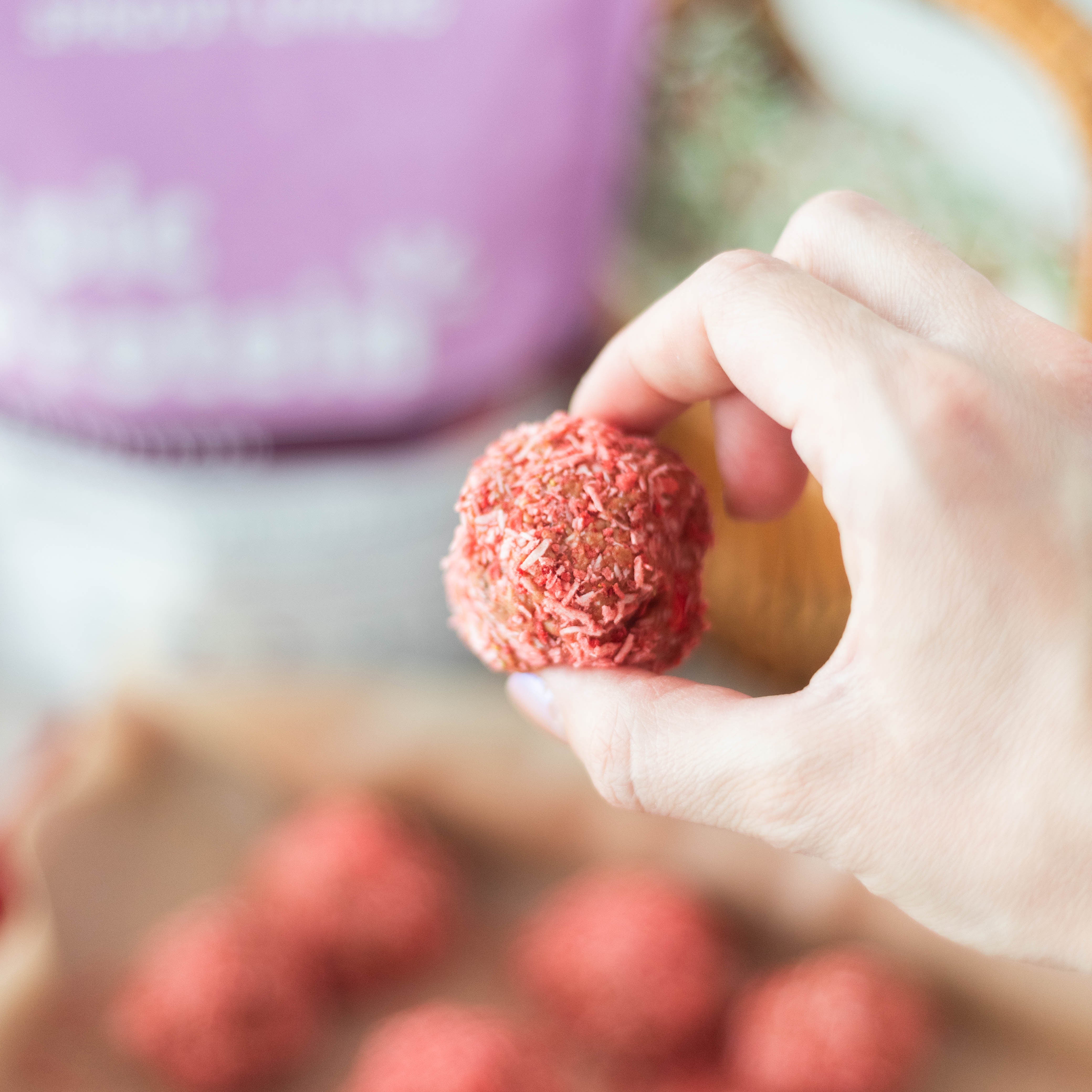 Hand Holding Strawberry Protein Bite