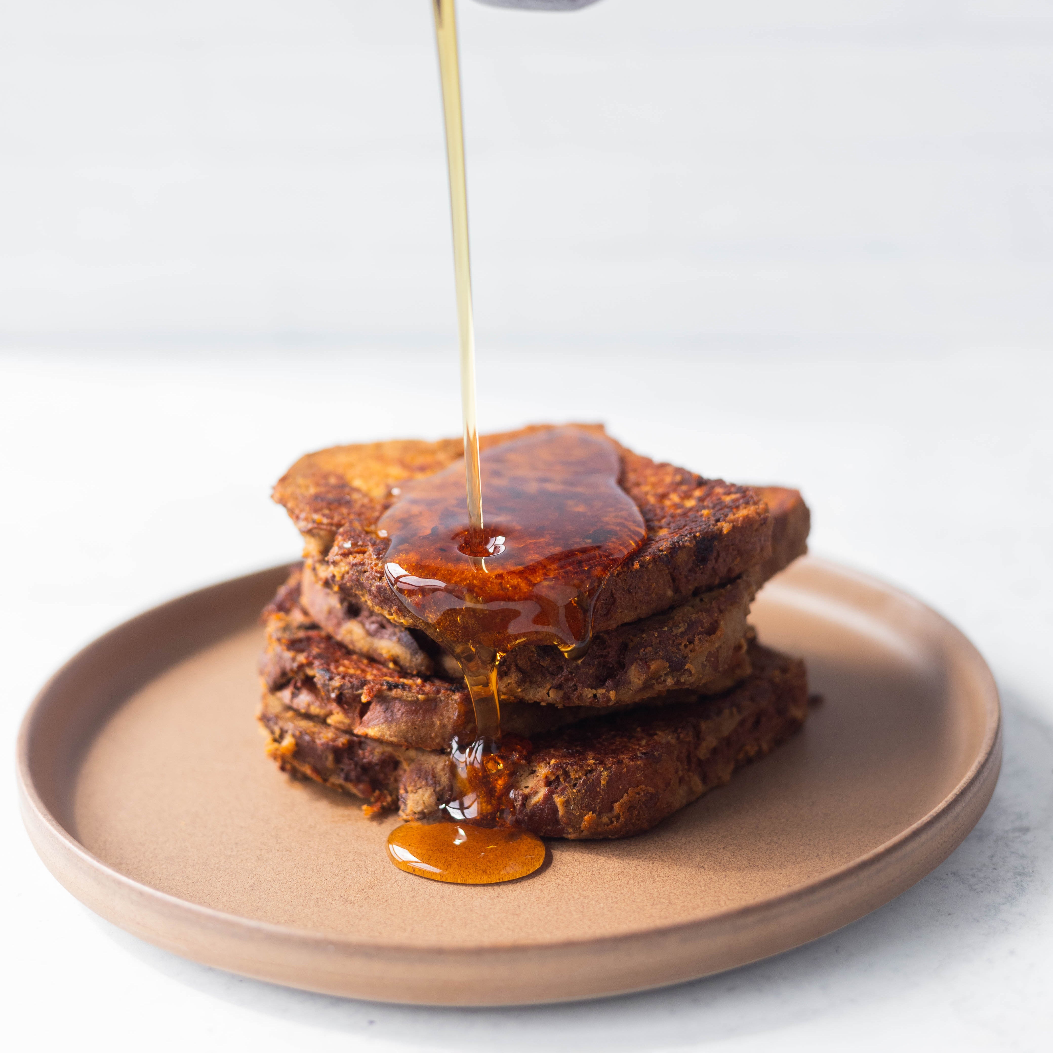 Syrup Being Drizzled Over Plate of French Toast