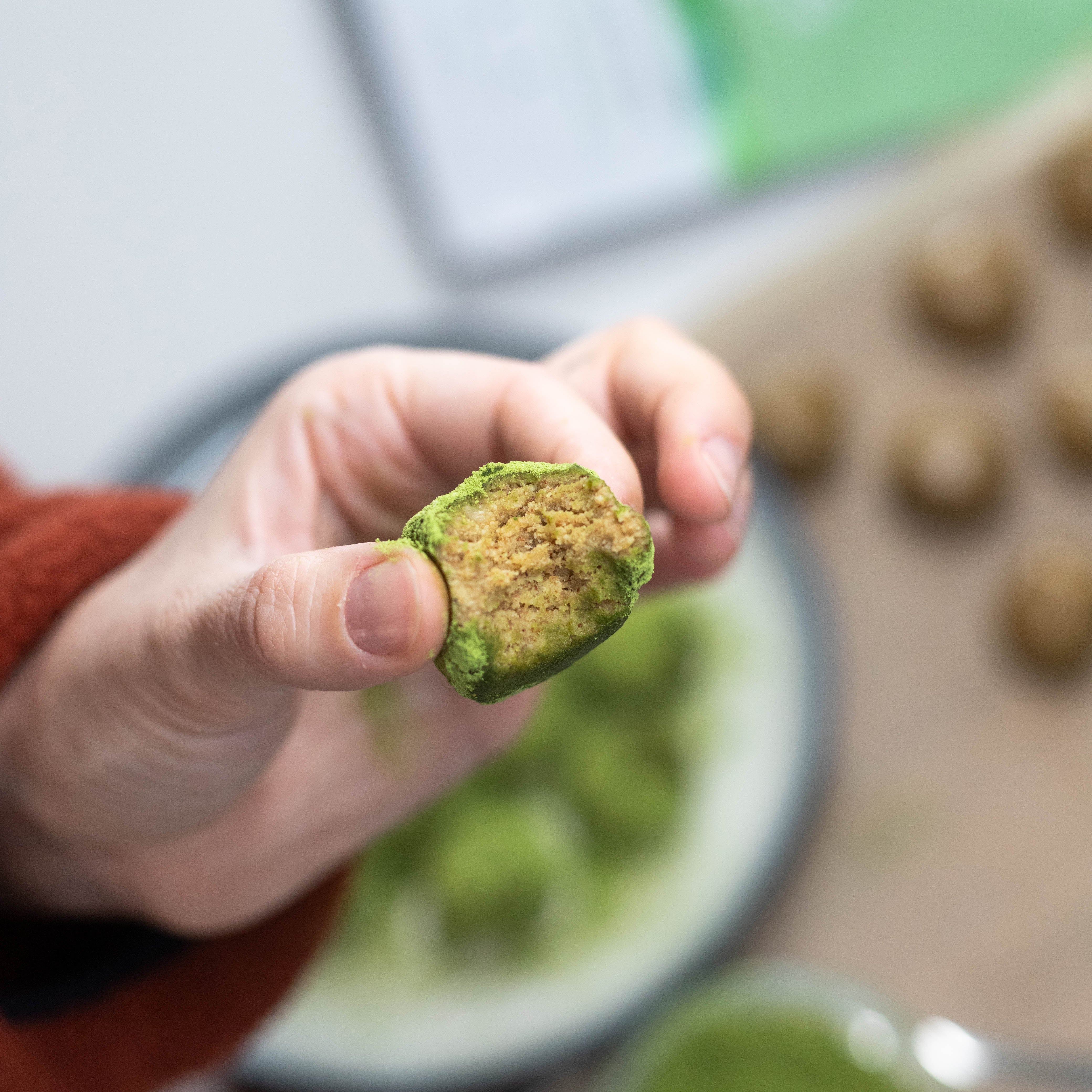 Hand Holding Green Protein Bite