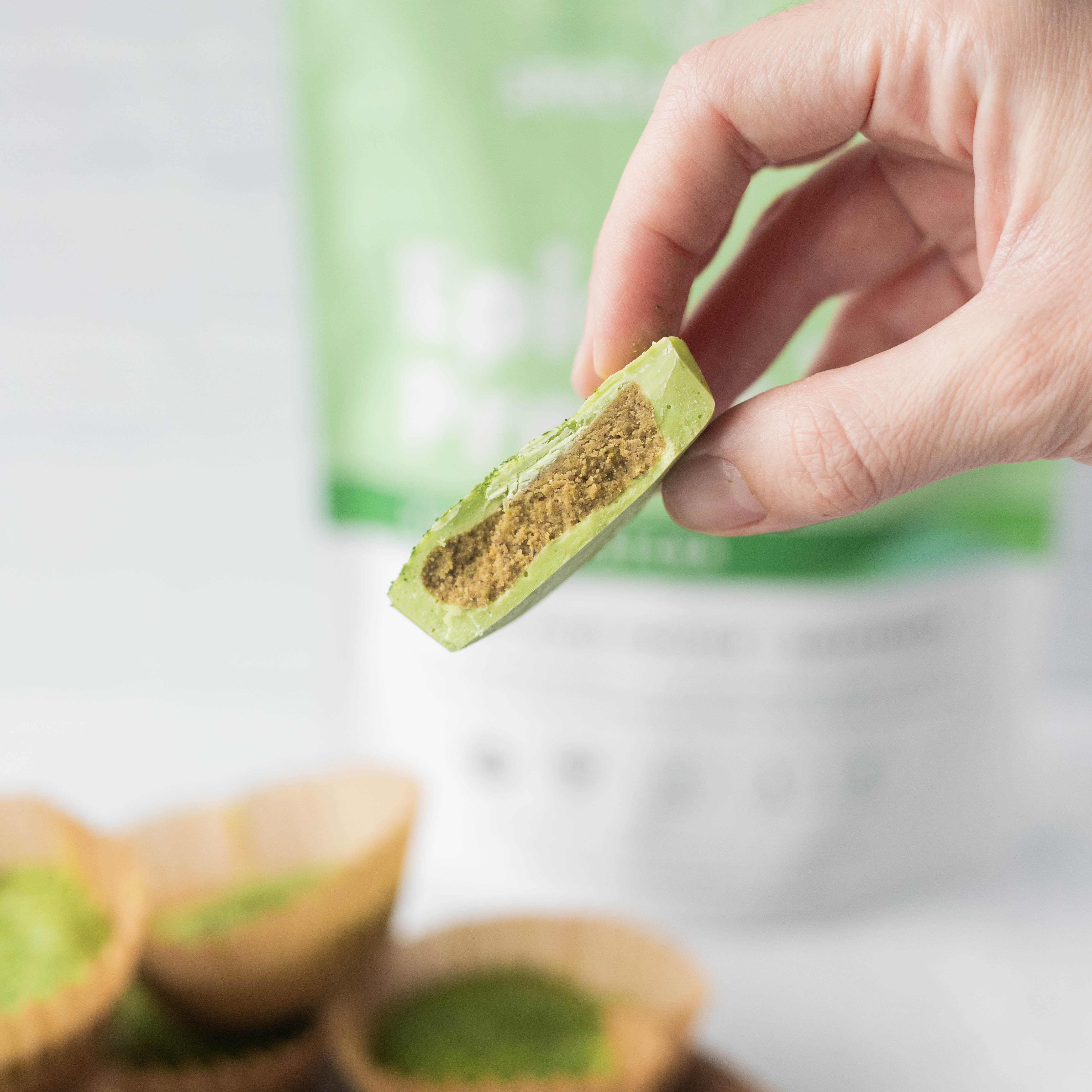 Hand Holding Matcha White Chocolate Protein Cups