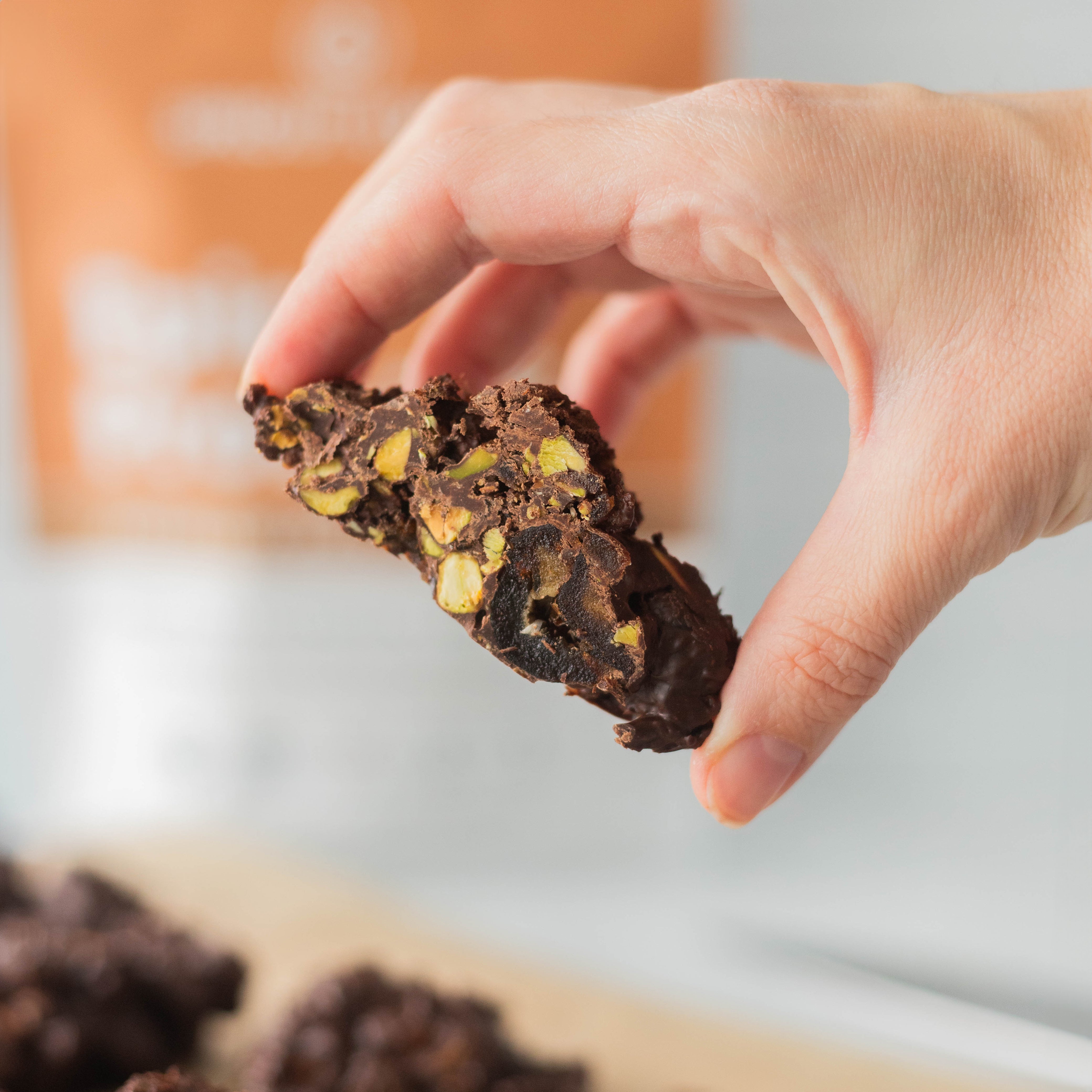 Hand Holding Healthy Protein Dark Chocolate Cluster