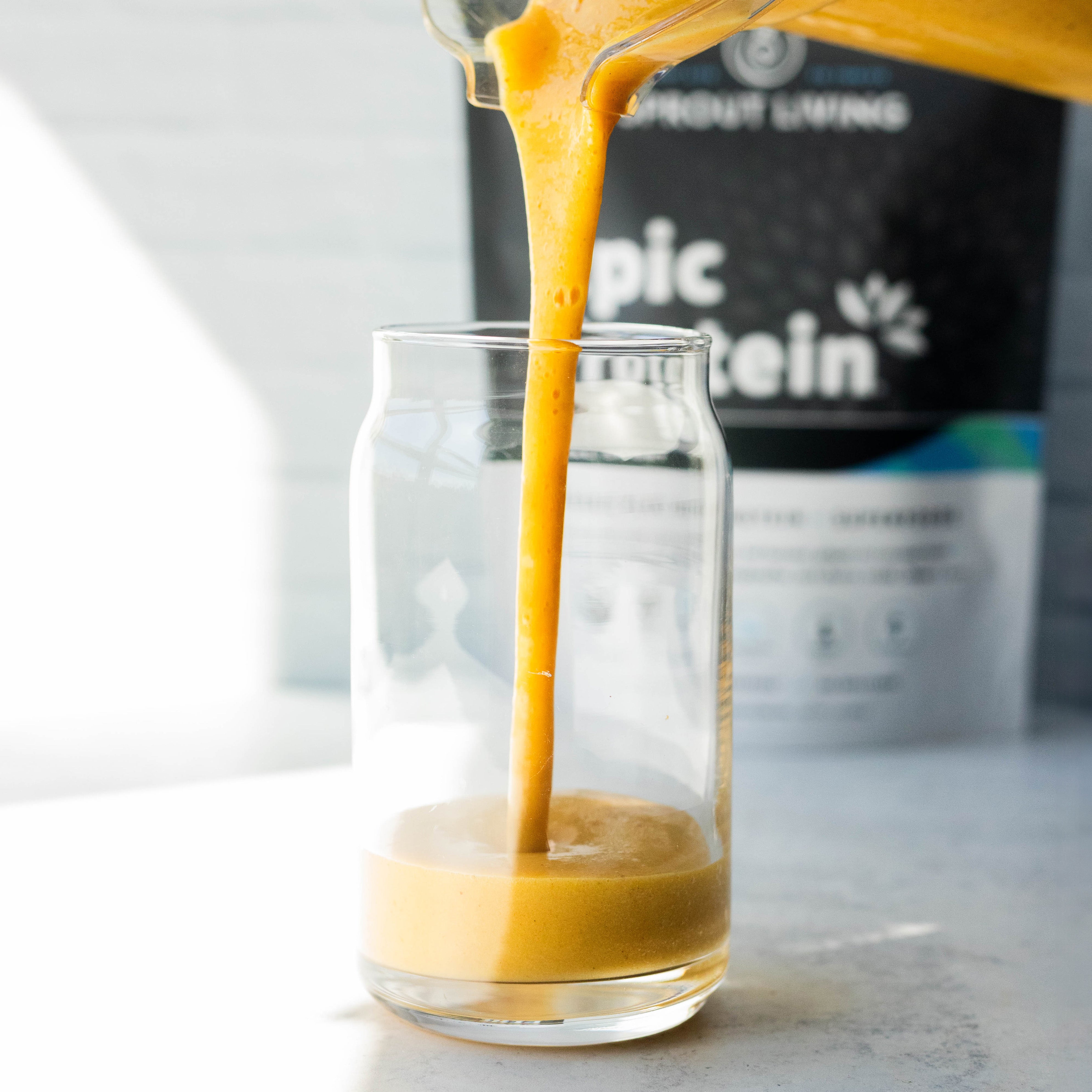 Orange Smoothie Being Poured Into Glass