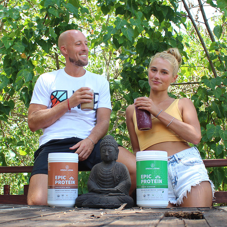 two ppl drinking epic protein in the woods