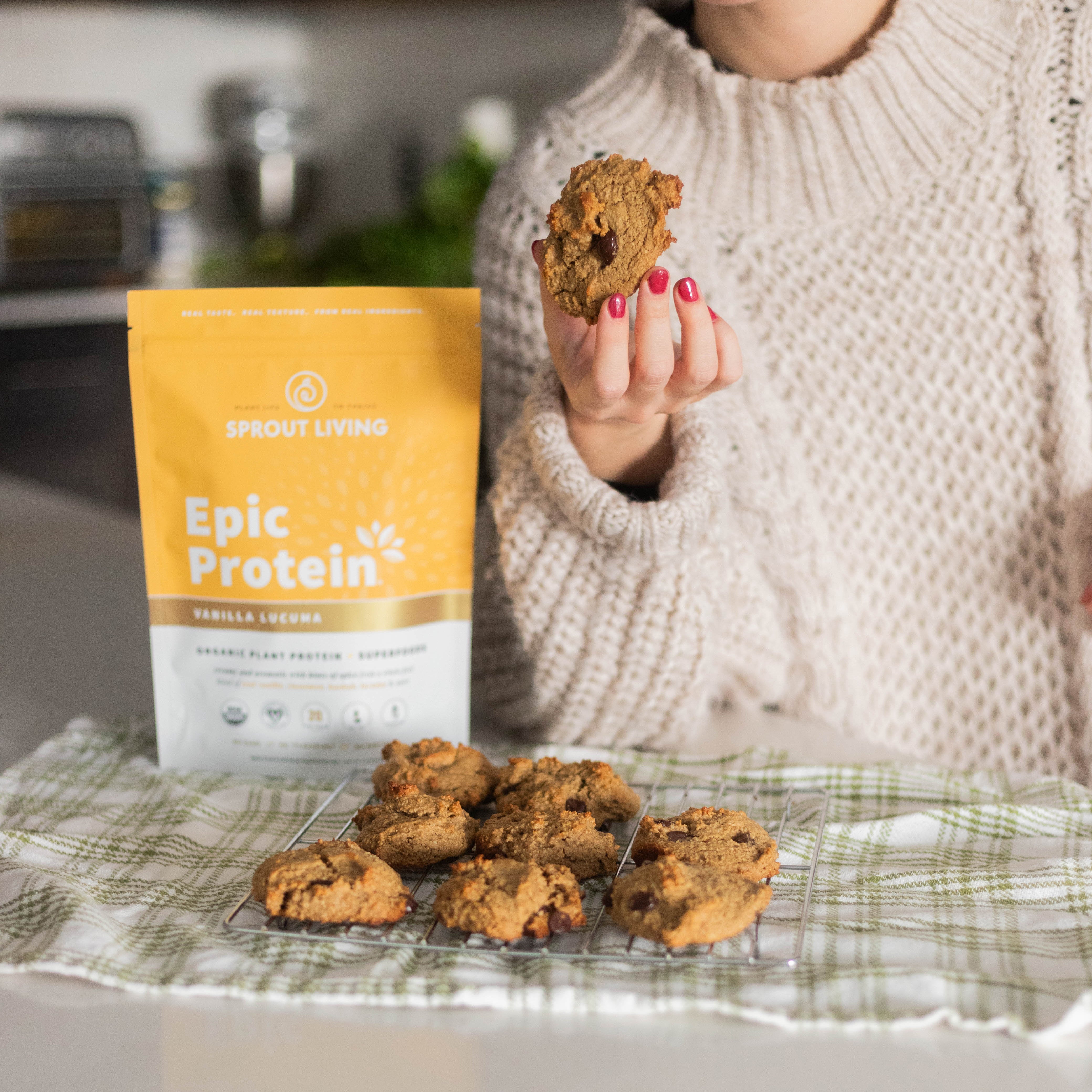 Woman Holding Fluffy Protein Cookie in Kitchen