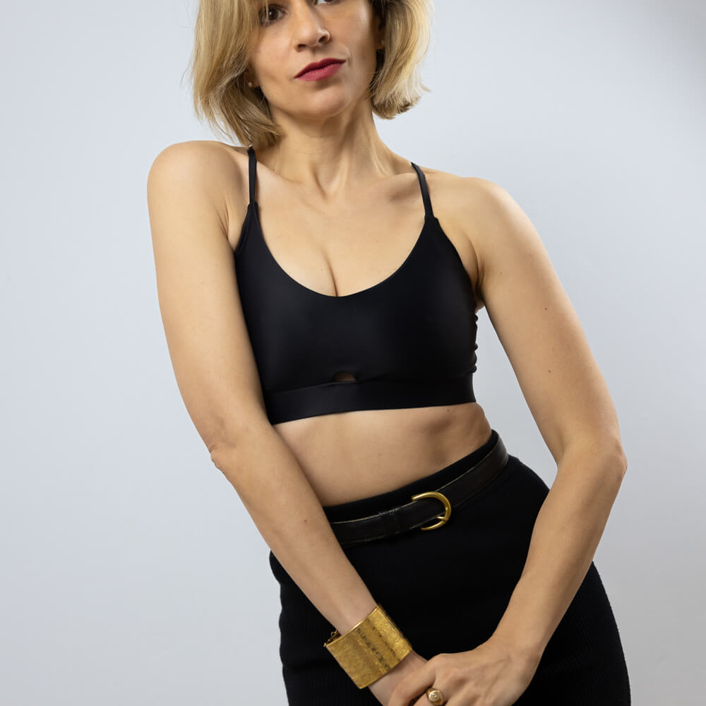 Woman wearing a black sports bra in sustainable fabric