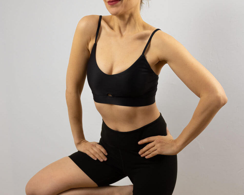 Woman doing yoga in a black sports bra