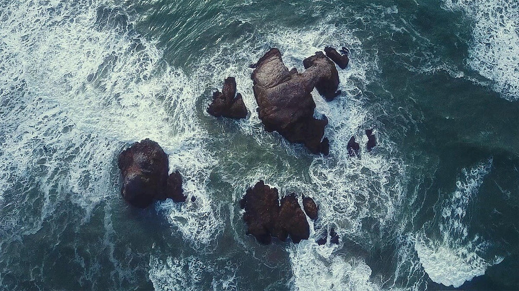 birds eye view of ocean rocks and waves