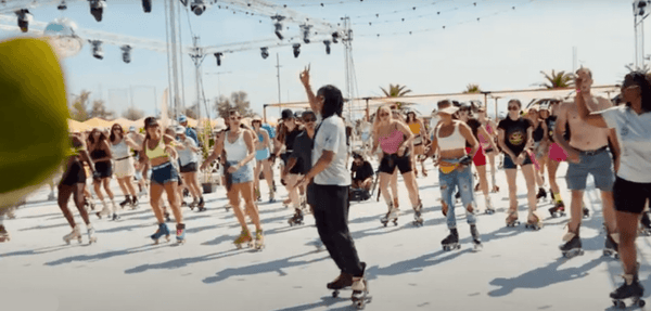 instructor teaching a roller skating class at the beach