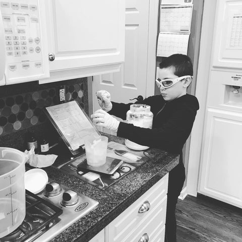 Celtic Clan Soapery Kitchen Boy measuring oils for natural soap making 