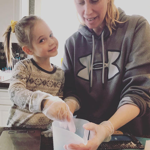 In the Celtic Clan Soapery Kitchen little girl mixing soap with mother 