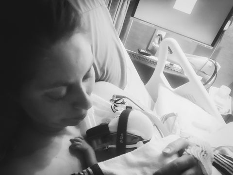 mom holding new born on breathing tube 