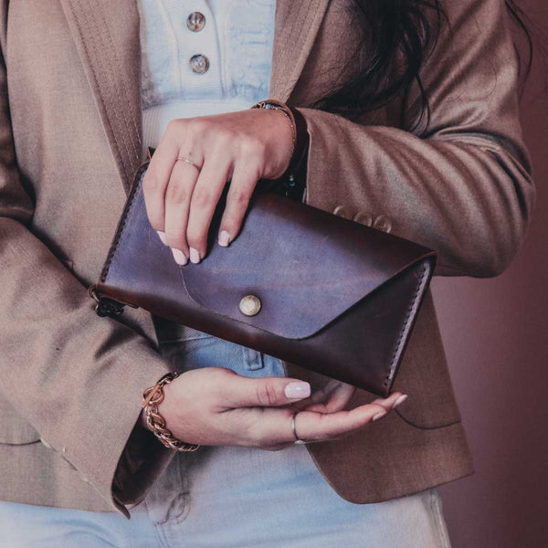 a wristlet clutch in a woman's fashion