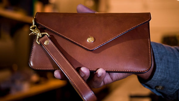 What is a leather wristlet clutch?
