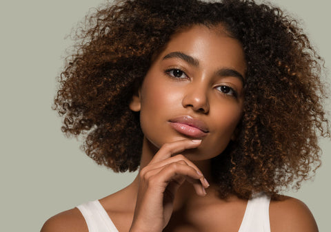 woman with curly hair after acv hair rinse