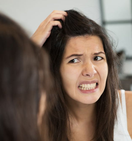 woman scratching itchy scalp