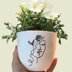 Flower pot with line art face design as a gift idea